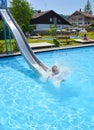 Outdoor pool water slide child kid happy Royalty Free Stock Photo