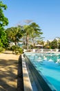 Outdoor pool on white sand beach property of modern residential neighborhood with colorful town houses/homes. Royalty Free Stock Photo