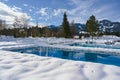 Outdoor Pools at winter time with snow around at snowy Rest Area with Deckchairs in Resort in Bavaria, Germany on winter day Royalty Free Stock Photo
