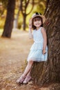 Outdoor portrait of adorable little girl dressed up in white dress Royalty Free Stock Photo