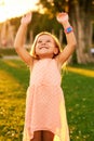 Outdoor portrait of adorable 3 or 4 year old girl playing in summer park Royalty Free Stock Photo