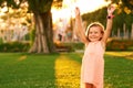 Outdoor portrait of adorable 3 or 4 year old girl playing in summer park Royalty Free Stock Photo