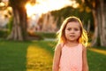 Outdoor portrait of adorable 3 or 4 year old girl playing in summer park Royalty Free Stock Photo