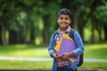 Outdoor portrait afro american happy school boy with books and backpack. Young student beginning of class after vacation