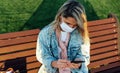 Outdoor portrait of the attractive blonde young woman smiling broadly wearing blue denim jacket in the park. Happy cheerful girl Royalty Free Stock Photo