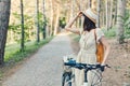 Outdoor portrait of attractive young brunette in a hat on a bicycle. Royalty Free Stock Photo