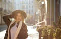 Outdoor portrait of awesome blonde girl wearing hat, scarf and c