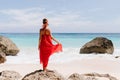 Outdoor portrait from back of wonderful caucasian woman enjoying sea views in weekend. Full-length