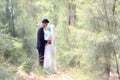 Outdoor portrait of a beatiful malay bride and groom couple in a garden