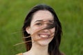 Outdoor portrait of beautiful girl laughing while the wind moves Royalty Free Stock Photo