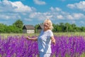 Outdoor portrait of a beautiful happy middle aged blonde woman in a field with flowers Royalty Free Stock Photo