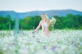 Outdoor portrait of a beautiful middle aged blonde woman. attractive girl in a field with flowers daises Royalty Free Stock Photo