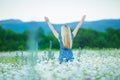 Outdoor portrait of a beautiful middle aged blonde woman. attractive girl in a field with flowers daises Royalty Free Stock Photo