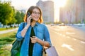 Outdoor portrait of a beautiful 40s woman talking on phone with shopping bags Royalty Free Stock Photo
