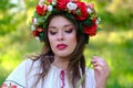 Outdoor portrait of a beautiful young Ukrainian woman with a wreath and in traditional national clothes. Close-up Royalty Free Stock Photo