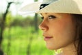 Outdoor portrait of beautiful young woman cowgirl