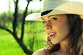 Outdoor portrait of beautiful young woman cowgirl