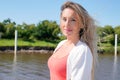 Outdoor portrait of beautiful young woman with a windy blonde blowing long hair in park nature background Royalty Free Stock Photo