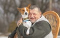 Outdoor portrait of Caucasian senior man with his cute basenji dog Royalty Free Stock Photo