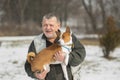 Outdoor portrait of Caucasian senior man taking his lovely basenji dog Royalty Free Stock Photo