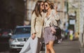 Outdoor portrait of caucasian young women enjoying good day. Two beautiful women walking are happy, smiling and looking Royalty Free Stock Photo