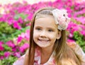 Outdoor portrait of cute little girl near the flowers Royalty Free Stock Photo