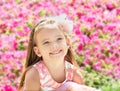 Outdoor portrait of cute little girl near the flowers Royalty Free Stock Photo