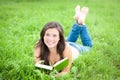 Outdoor portrait of a cute reading teen