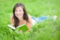 Outdoor portrait of a cute reading teen