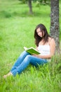 Outdoor portrait of a cute reading teen