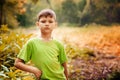 Outdoor portrait of a cute serious boy.