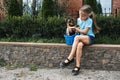 Outdoor portrait of cute Yorkshire terrier puppy in basket and preteen girl. Liitle girl holding dog breed Yorkshire Royalty Free Stock Photo