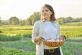 Outdoor portrait of farmer woman with basket of fresh chicken eggs, farm Royalty Free Stock Photo