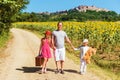 Outdoor portrait of a funny little kids and the father walking down the road Royalty Free Stock Photo