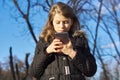 Outdoor portrait girl child of 8, 9 years old with smartphone Royalty Free Stock Photo