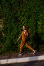 Outdoor portrait of girl in sport costume walking city streets Royalty Free Stock Photo