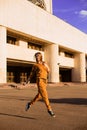 Outdoor portrait of girl in sport costume walking city streets Royalty Free Stock Photo