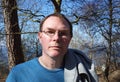 Outdoor portrait of handsome adult serious looking man