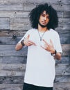 Outdoor Portrait Of Handsome African Young Man Making Gestures. Afro hairstyle. Royalty Free Stock Photo