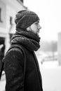 Outdoor portrait of handsome man in gray coat. Fashion photo. Beauty winter snowfall style. Black and White Royalty Free Stock Photo