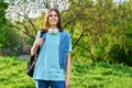 Outdoor portrait of handsome student guy with backpack looking at camera Royalty Free Stock Photo