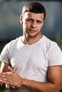 Outdoor portrait of a handsome young man in jeans and gray t-shirt. Royalty Free Stock Photo