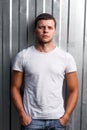 Outdoor portrait of a handsome young man in jeans and gray t-shirt. Royalty Free Stock Photo