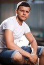 Outdoor portrait of a handsome young man in jeans and gray t-shirt. Royalty Free Stock Photo