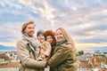 Outdoor portrait of happy family of four, young couple with two little children, cold weather, Royalty Free Stock Photo