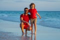 Outdoor portrait of happy father and son hugging on sunny ocean beach. Father and son walk in sea beach. Concept of Royalty Free Stock Photo