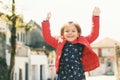 Portrait of happy jumping little girl, early spring or fall image Royalty Free Stock Photo