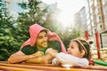 Outdoor portrait of happy kid, cute little girl smiling and playing with her daddy. Handsome dad and toddler child having fun and Royalty Free Stock Photo