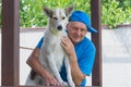 Outdoor portrait of happy mature man and his cute young dog Royalty Free Stock Photo