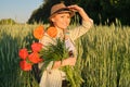 Outdoor portrait of happy mature woman with bouquets of red poppies flowers Royalty Free Stock Photo